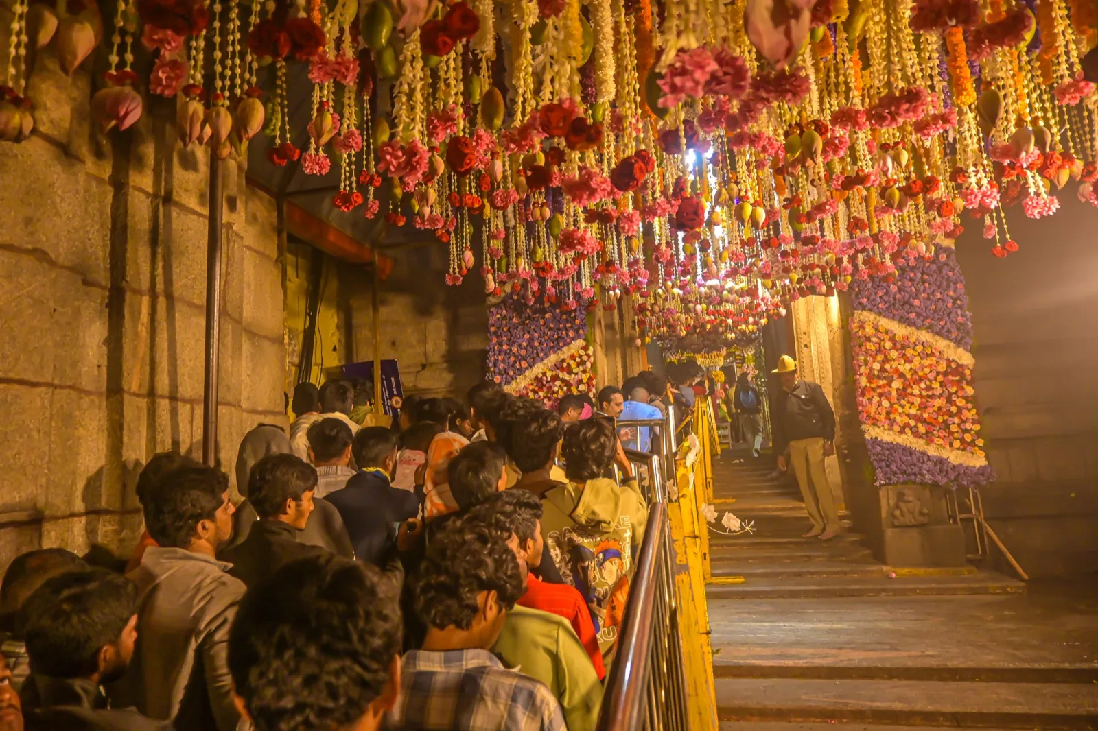 Devotees amid festive garlands in the temple corridor
